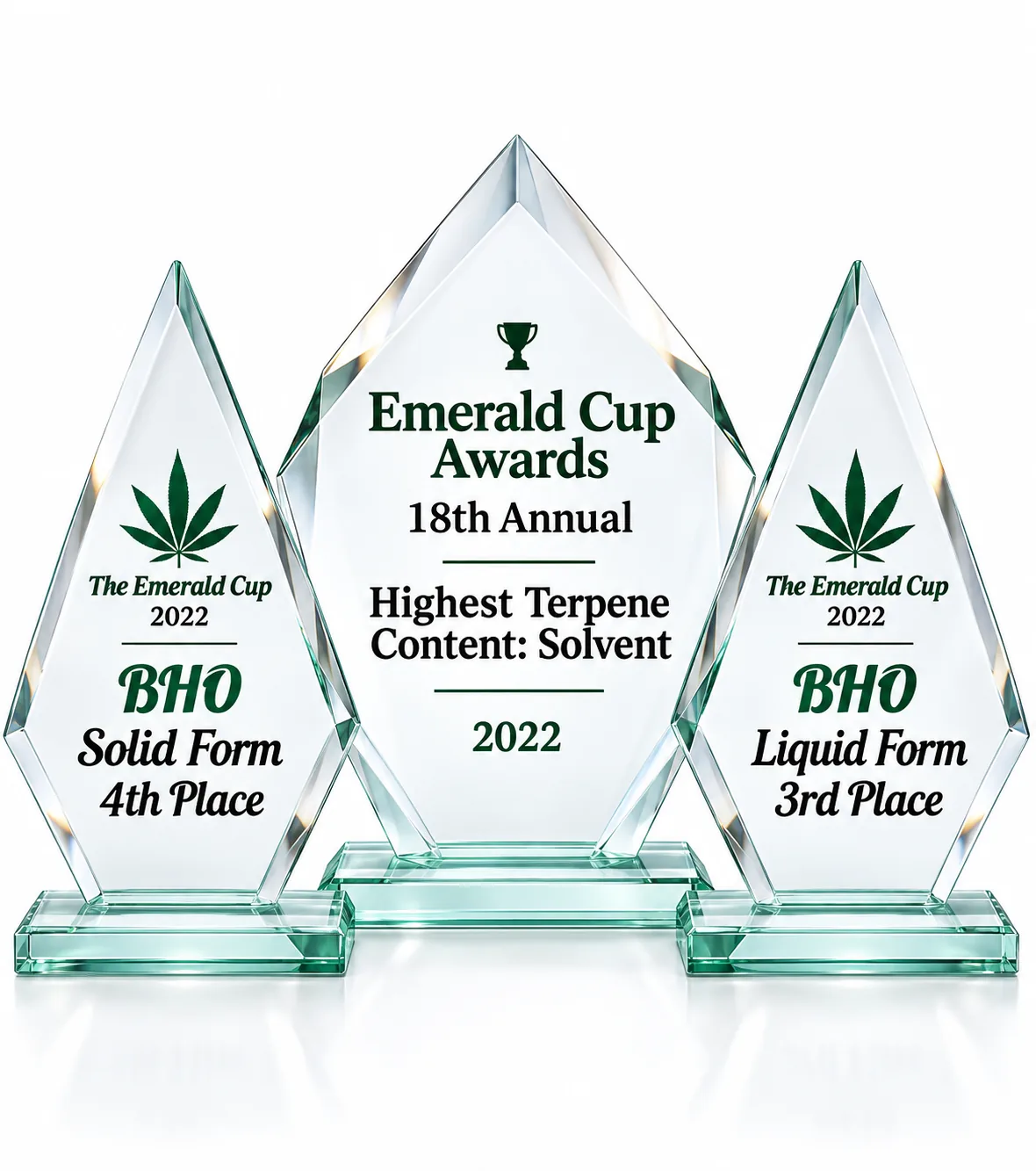 Three glass trophies from the 18th Annual Emerald Cup recognizing BHO solid form, solvent terpene content, and BHO liquid form.