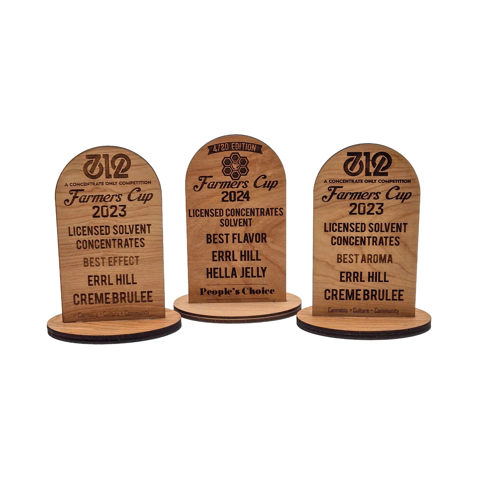 Three Farmers Cup trophies recognizing Errl Hill's Creme Brulee in 2023 and Hella Jelly in 2024.